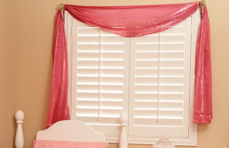 Girl's bedroom with plantation shutters.
